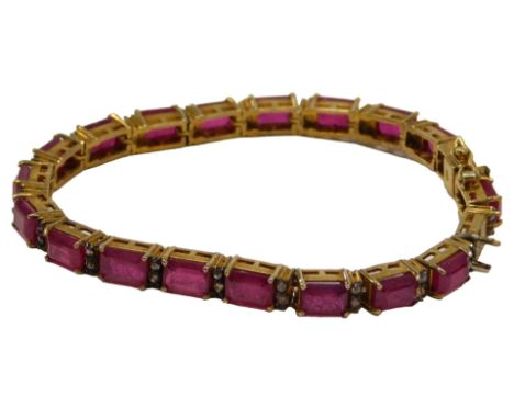 A tennis bracelet, set with ruby and garnets, in a gold finish setting, stamped 925, one stone loose, 18cm long, 19.5g all in