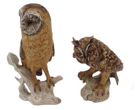 Two Goebel owls, one standing on a tree perch, 23cm and 18cm high.