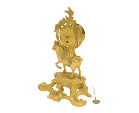 A 19thC French gilt brass table clock, of rococo scrolling form with a bull mounted by a cartel form, dial with Roman numeral