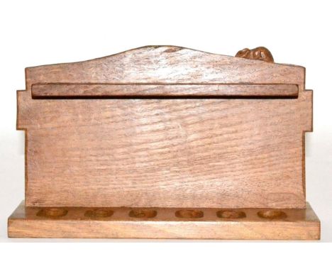 A Robert Mouseman Thompson Oak Pipe Rack, with six holders, shaped square back and carved mouse signature, 28cm by 17cm