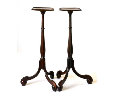 A Pair of George III Mahogany Tripod Candlestands, early 19th century, of octagonal shaped form, raised on chamfered baluster
