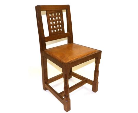 A Robert ''Mouseman'' Thompson Oak Lattice Back Dining Chair, with cow hide upholstered seat, on two octagonal turned front l