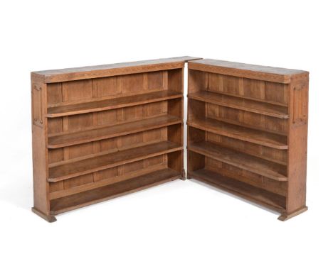 A Thomas ''Gnomeman'' Whittaker Oak Two-Section Bookcase, each section fitted with three adjustable shelves with penny moulde