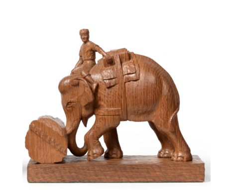 Stan Dodds (1928-2012): A Carved Oak Group, of a Mahout riding an Indian elephant, the elephant is using the trunk to push a 