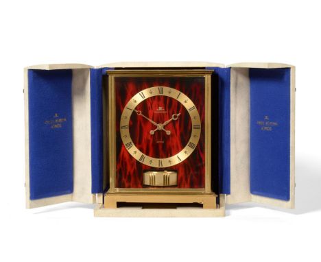 A Brass Atmos Clock, signed Jaeger LeCoultre, model: Embassy Red, circa 1969, case with red faux marble front and side panels