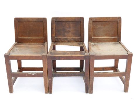 Three Robert ''Mouseman'' Thompson Oak Panel Back Chairs, solid seats, joined by rails, each with recessed carved mouse signa