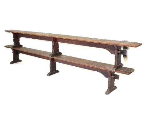 A Pair of Robert ''Mouseman'' Thompson Oak 12ft Benches, on three shaped supports, joined by a rail (top), unmarked, 366cm wi