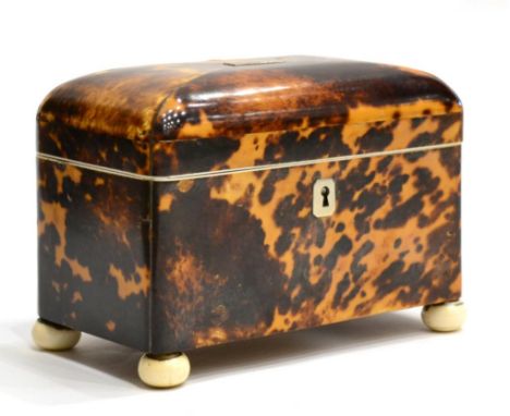 A Tortoiseshell Tea Caddy, early 19th century, of domed rectangular form, opening to reveal two lidded compartments, on bun f