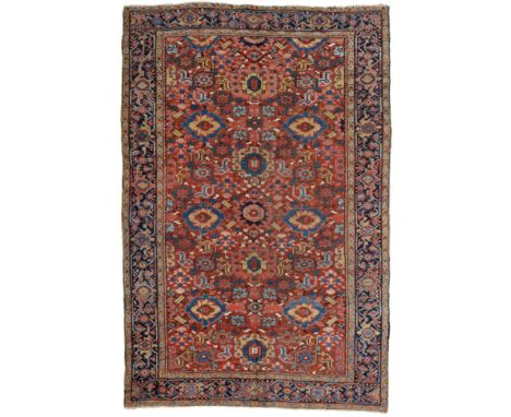 Unusual Heriz Carpet Iranian Azerbaijan, circa 1900 The brick red field with columns of polychrome stylised flowerheads enclo