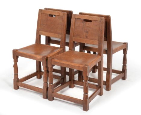 A Set of Four Robert ''Mouseman'' Thompson Burr Oak Panel Back Chairs, with aperture handle, slung leather seats and on octag