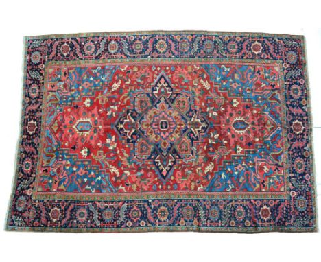 Heriz Carpet Iranian Azerbaijan, circa 1900 The tomato field of angular vines centred by a deep indigo salmon pink and mustar