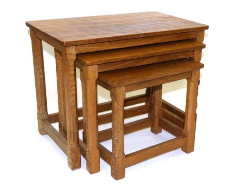 A Robert ''Mouseman'' Thompson Nest of Three Oak Tables, each with adzed top raised on octagonal legs and block feet joined b