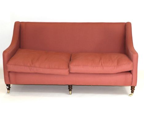 A Victorian Style Three-Seater Sofa, upholstered in pink cotton fabric with two squab cushions above a plain seat rail, raise