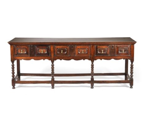 A Late 17th Century Oak Dresser, the rectangular top above three two-as-one geometric moulded drawers, raised on bobbin turne