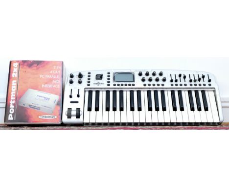 A M-Audio Ozonic 37 key midi control keyboard, with manual, together with a Portman 2x4 midi interface 