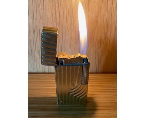 A Dunhill 70 pocket cigarette lighter, gold plated with bark effect decoration. 