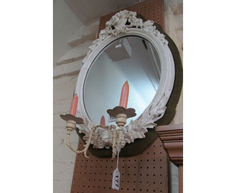 A Victorian white porcelain mirror with leaf and bird cresting with replacement metal candlesconces purchased from Garrards