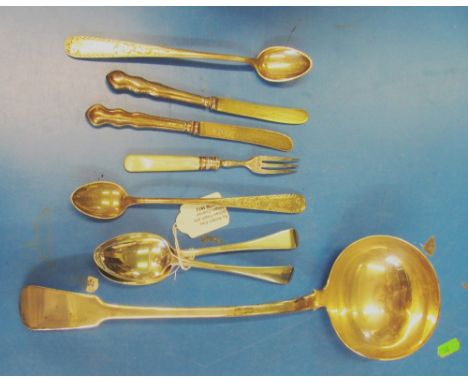 A silver ladle spoon and other silver flatware