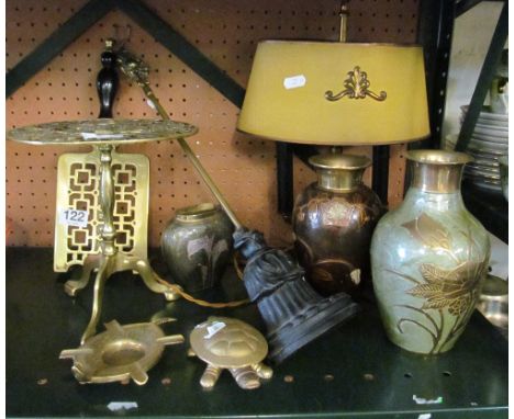 Two brass trivets, brass table lamp, three metalware vases and a doorstop