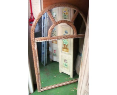 A wicker frame mirror