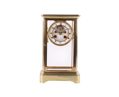 A late 19th century French gilt brass full pillar mantel clock, the case with bevel edged glass panels, on a plinth base, the
