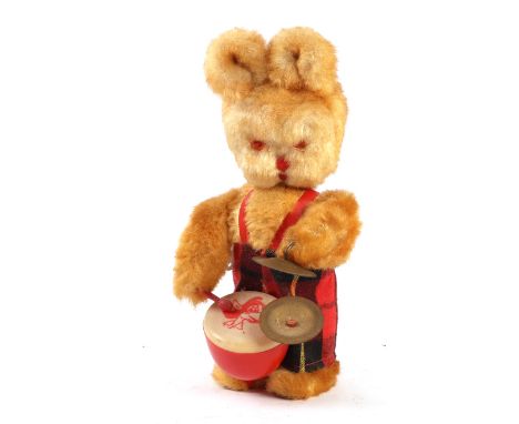 A vintage clockwork plush rabbit playing a drum and cymbals, 25cms high.