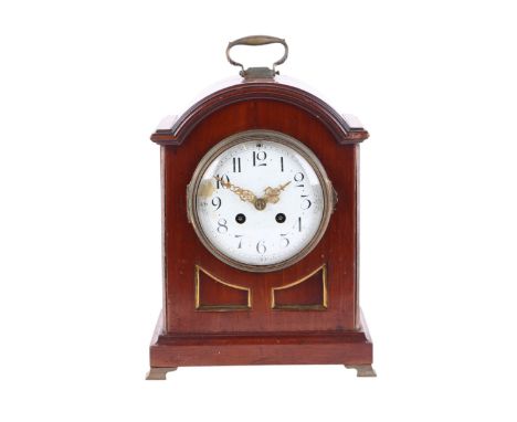 An Edwardian mahogany cased mantel clock, the white enamel dial with Arabic numerals, 29cms high.