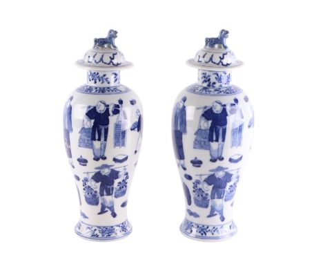 A pair of Chinese blue & white baluster vases and covers decorated with figures, four character blue mark to the underside, 3