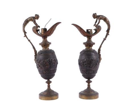 A pair of bronze and gilt ewer form table lamps with figural handle, 34cms high (2).