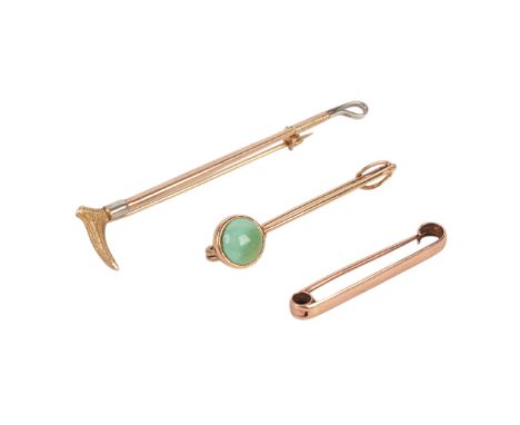 Hunting interest.  A 9ct gold riding crop bar brooch with 18ct white gold mounts, 7cms long; together with a yellow metal tur