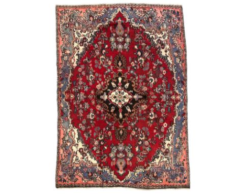 A Persian Hamadan woollen hand knotted rug with central floral gul, on a beige ground, 155 by 225cmsCondition ReportEdges of 