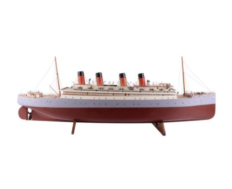 A fine Basset-Lowke boardroom model of the Warwick Castle, the laminated and carved wooden hull finished in red and lavender 