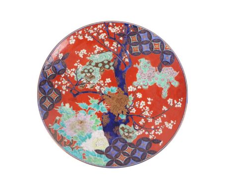 A large Japanese charger decorated with a stylised prunus tree, four character mark to the underside, 48cms diameter.