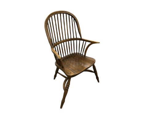 A farmhouse Windsor comb back beech and yew armchair with carpet saddle bag seat cushion (2).