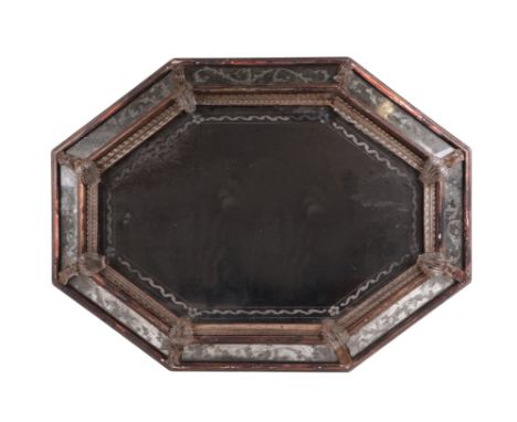 An 18th century cushion shaped mirror with ornate edge panels, overall 54 by 71cms.