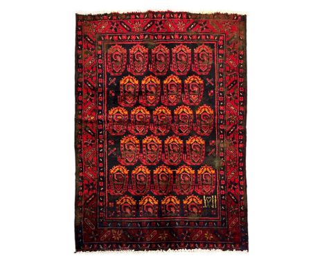A Persian Hamadan hand knotted woollen rug with repeating boteh design within floral borders, on a navy blue ground, 110 by 1