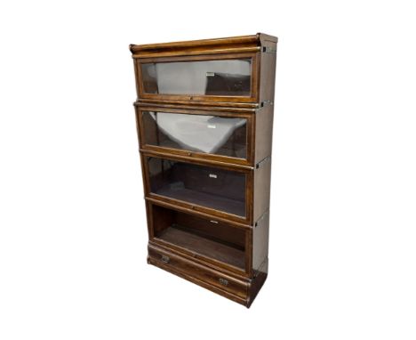 An early 20th century Globe Wernicke walnut Barrister's four-section stacking bookcase with drawer beneath, 87cms wide, 158cm