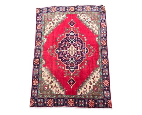 A Persian Tabriz hand knotted woollen rug with floral design within multi borders, 130 by 190cms.
