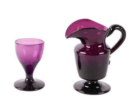 A Victorian amethyst glass cream jug; together with a similar dram wine glass, the largest 12cms high (2).
