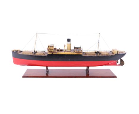 A Bassett-Lowke model of a general purpose cargo steamer, with carved wooden hull, details including rigged masts, derricks, 