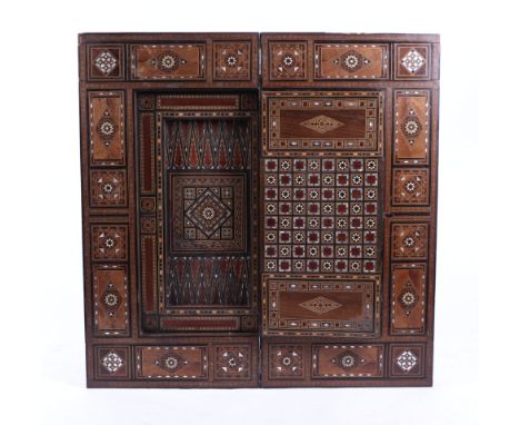 A Syrian Damascus mother of pearl and parquetry inlaid fold-over games table opening to reveal a velvet playing surface, back