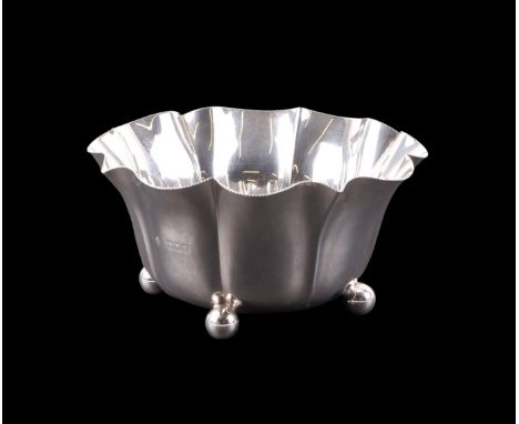 An Edwardian silver fluted bowl on four bun feet, London 1902 and retailer's mark for Penlington & Batty Liverpool, 15cms dia