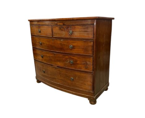 A late 19th century mahogany bow fronted chest of two short and three graduated long drawers, on compressed bun feet, 98cms w