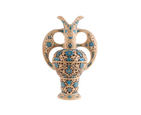 A Zsolnay Pecs reticulated two-handled vase decorated with blue glazed flowers, 41cms high.Condition ReportOne handle has bee