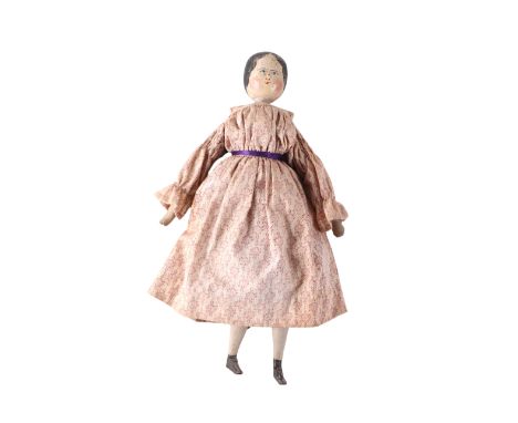 A folk art wooden doll, the head with painted decoration, one leg detached, 42cms overall height.Condition ReportThe leg is d