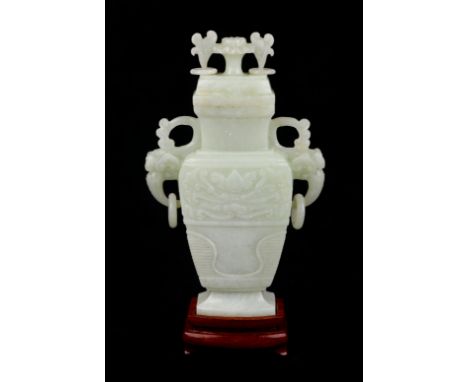 A Chinese pale jade vase and cover of flattened baluster form with flower finial on hardwood stand, in original box. 18.5cm h