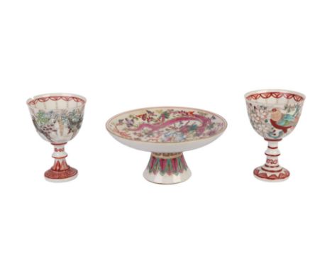 A pair of Chinese porcelain pedestal wine cups decorated with birds, 10.5cms high; together with a Chinese famille rose pedes