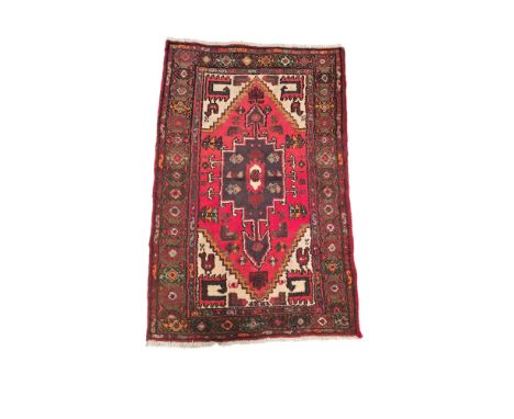A Persian Shiraz hand knotted woollen rug with geometric design and stylised birds, on a cream ground, 140 by 98cms.