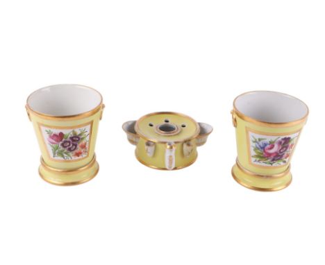 A 19th century drum shaped inkwell; together with two planters on stands decorated with flowers on a yellow ground, 13cms hig