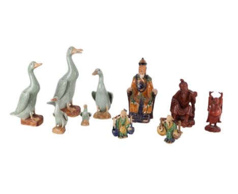 A set of five Chinese graduated figures of runner ducks, 23cms high; together with a Sancai glazed figure of a seated dignita